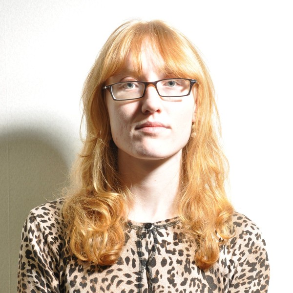 Unbalanced lighting, and eyeglasses are being worn.
