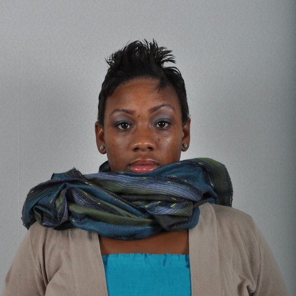 A scarf covers part of the face.